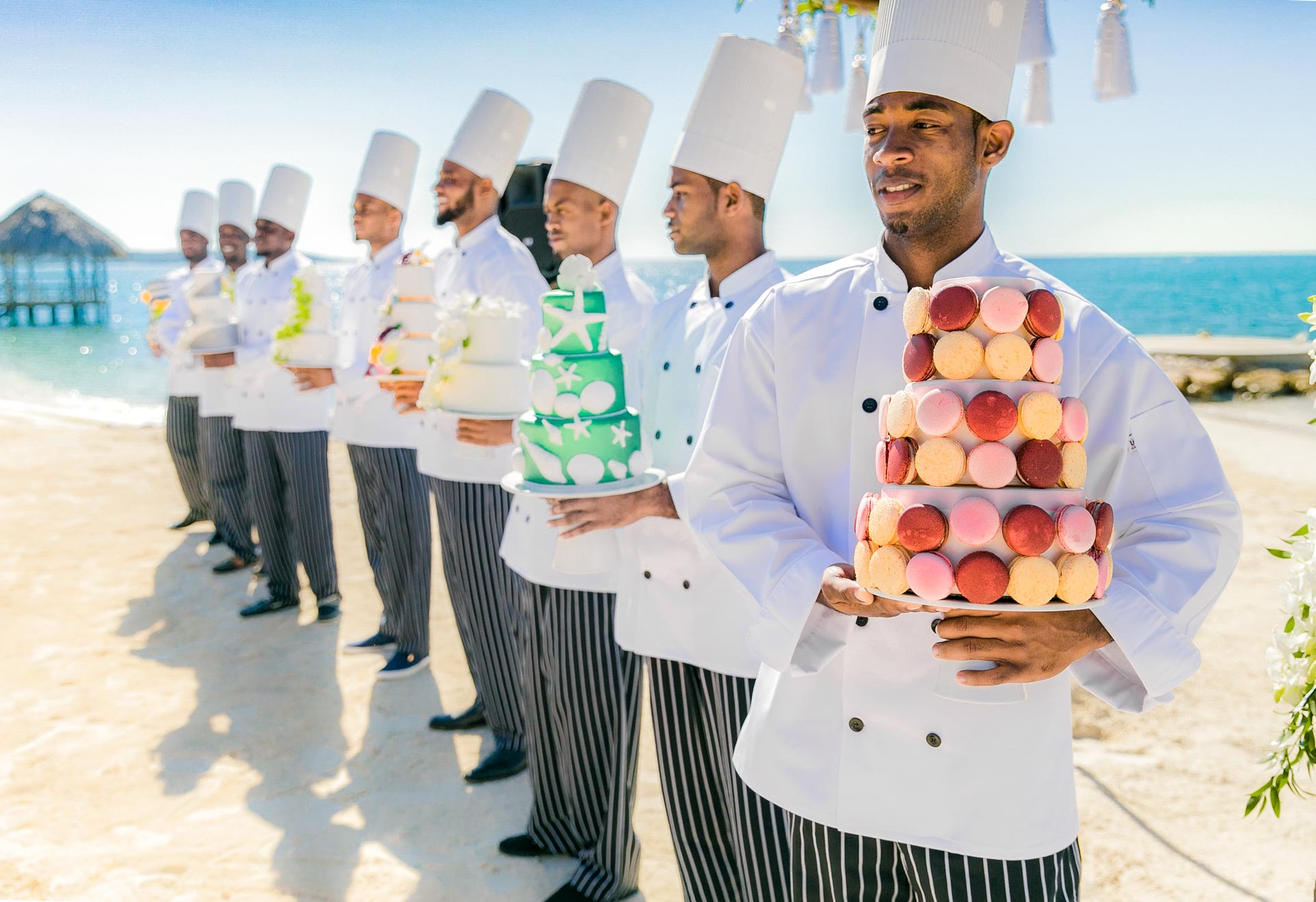 Row of chefs with cakes