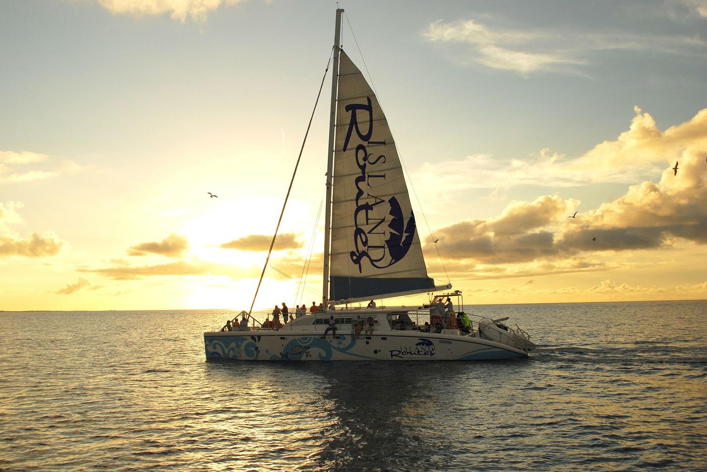 guests on board of the island routes catamaran cruise enjoying a sunset ride
